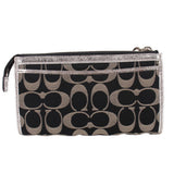 COACH signature black-and-silver wristlet pouch with zip pocket and wrist strap