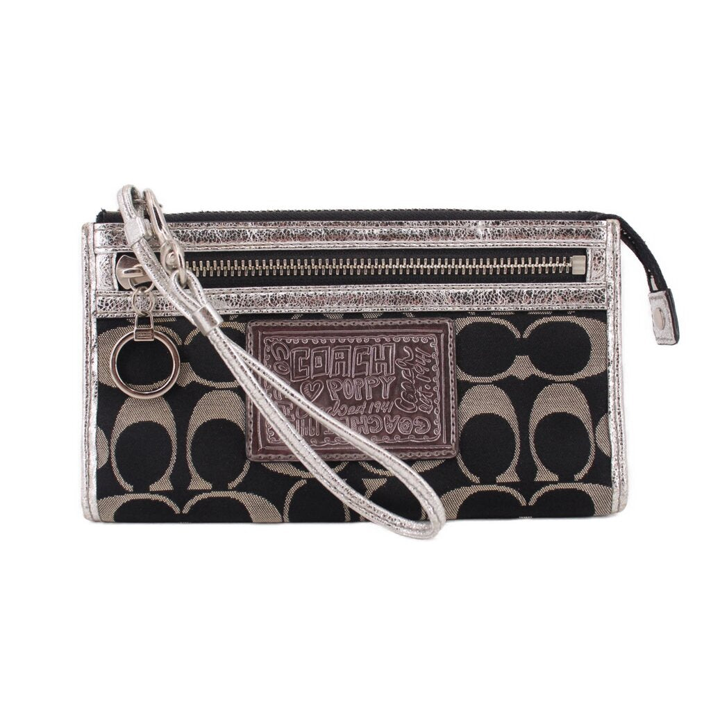 COACH signature black-and-silver wristlet pouch with wrist strap and zip closure
