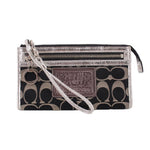 COACH signature black-and-silver wristlet pouch with wrist strap and zip closure