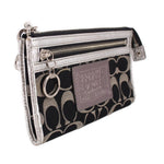 COACH signature wristlet pouch with wrist strap, top zipper, and hanging key ring