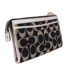 COACH signature wristlet pouch with side wrist strap, zip pocket, and metal hardware