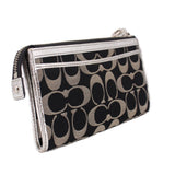 COACH signature wristlet pouch with side wrist strap, zip pocket, and metal hardware