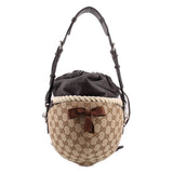 Brown logo bucket shoulder bag with black pouch top, braided rope belt, leather bow