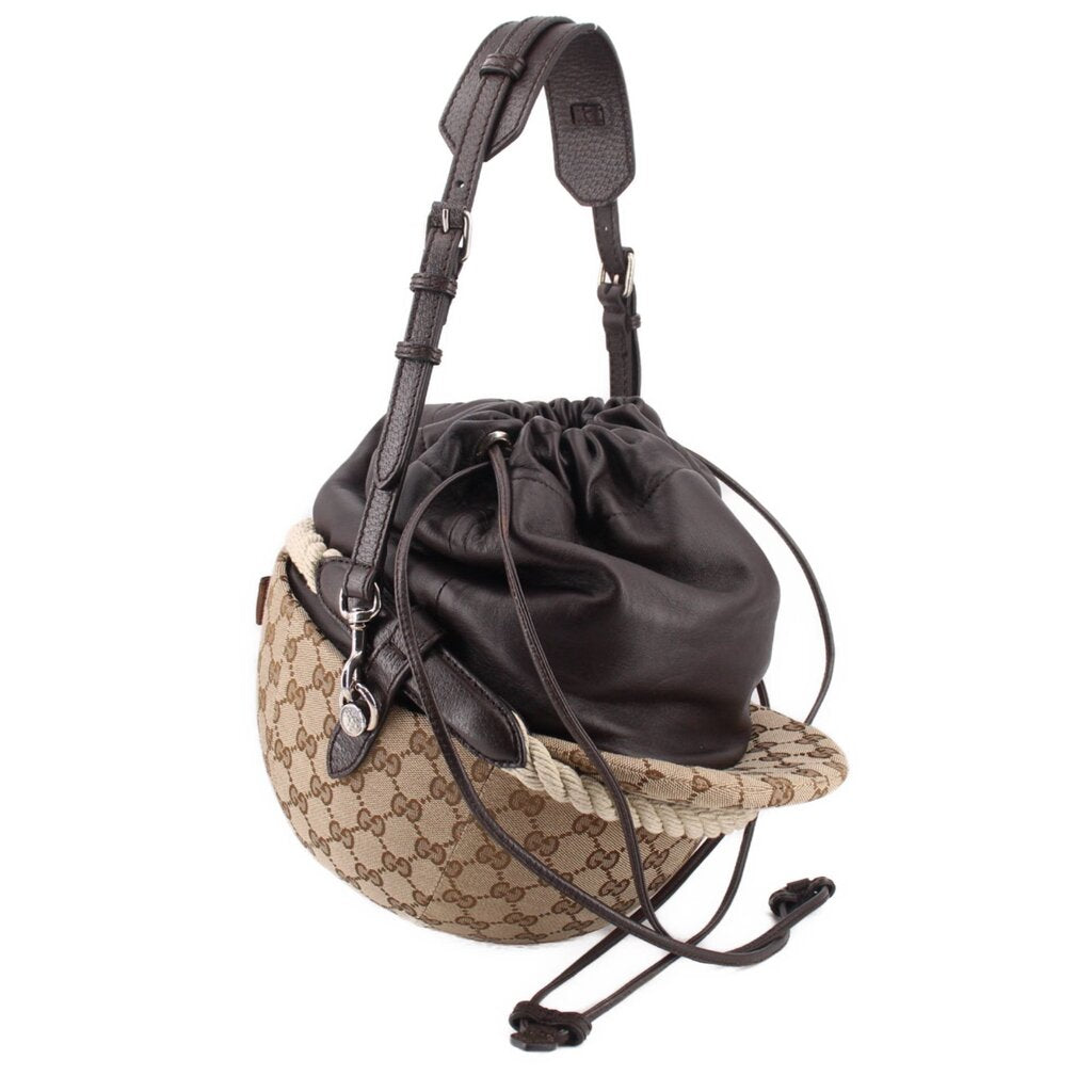 Brown logo canvas bucket shoulder bag with black drawstring pouch and leather strap