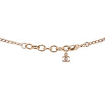Gold-tone necklace clasp with CHANEL logo charm and linked chain.