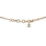 Gold-tone necklace clasp with CHANEL logo charm and linked chain.