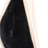 Crossbody bag interior close-up with dark lining and gold-tone zipper