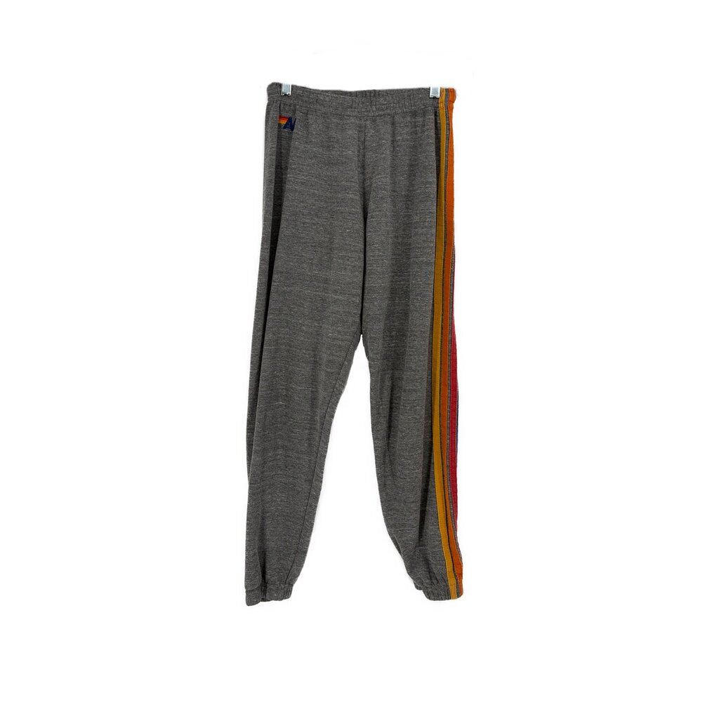 Gray jogger pants with elastic waist and tapered legs, orange side stripe