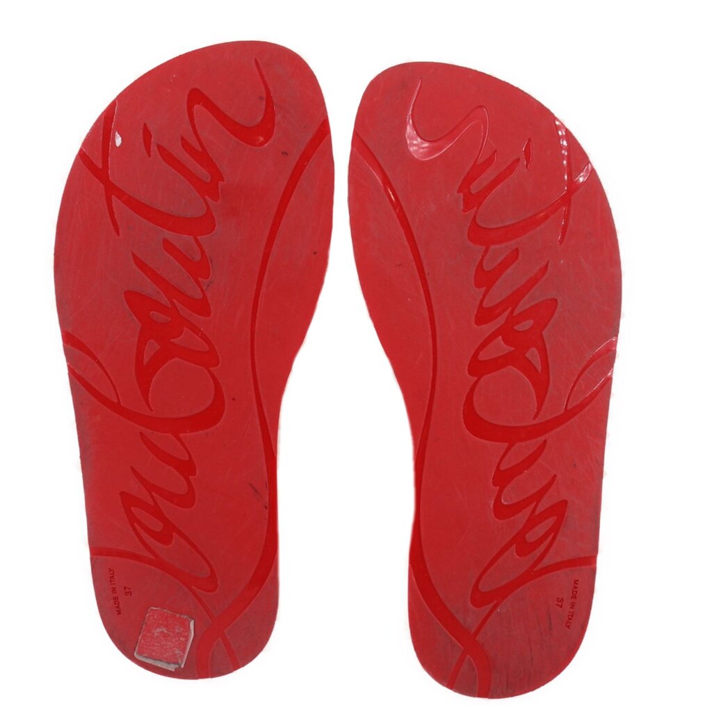 Red flip-flop outsoles with embossed signature lettering