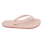 Blush flip-flop sandals with arch toe strap and red-trim studded outsole