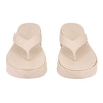 Cream rubber GUCCI flip-flop sandals, pair view showing embossed logo on straps