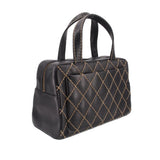 Black quilted mini handbag with gold lattice stitching and top handles, angled view