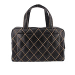 Black quilted handbag with gold diamond pattern and rounded top handles, front view