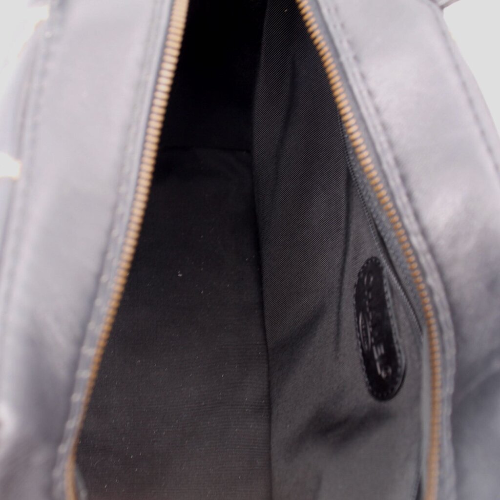 Black handbag interior with zipper track, showing inner lining and seam details