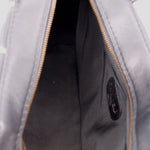 Black handbag interior with zipper track, showing inner lining and seam details