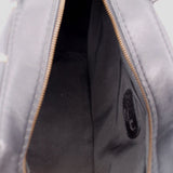 Black handbag interior with zipper track, showing inner lining and seam details