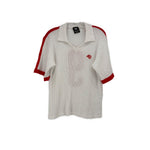 White jersey top with red striped trim, short sleeves, and small red logo on chest