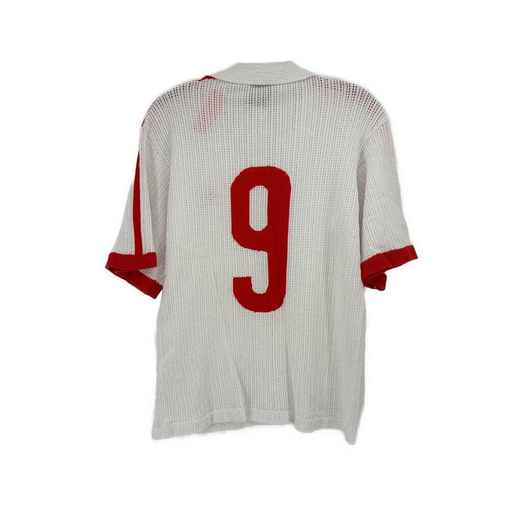 White jersey top back with large red number 9 and red striped sleeve trim