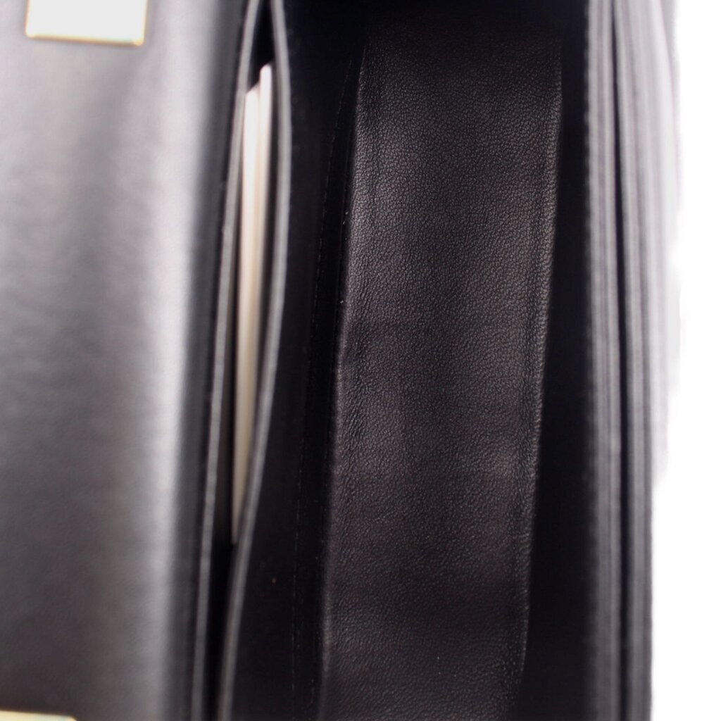 Black crossbody bag interior lining and side seam close-up