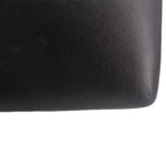 Black crossbody bag texture close-up on the side panel