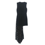 Black sleeveless dress with layered pleated skirt and textured hem panel