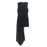 Black sleeveless dress with layered pleated skirt and textured hem panel