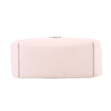 Cream leather crossbody bag back panel with stitched edges and smooth bottom, close view.