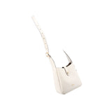 Cream mini crossbody bag hanging from adjustable strap with gold-tone button detail.