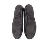 Black ballet flat outsoles with textured pattern, pair view