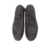 Black ballet flat outsoles with textured pattern, pair view