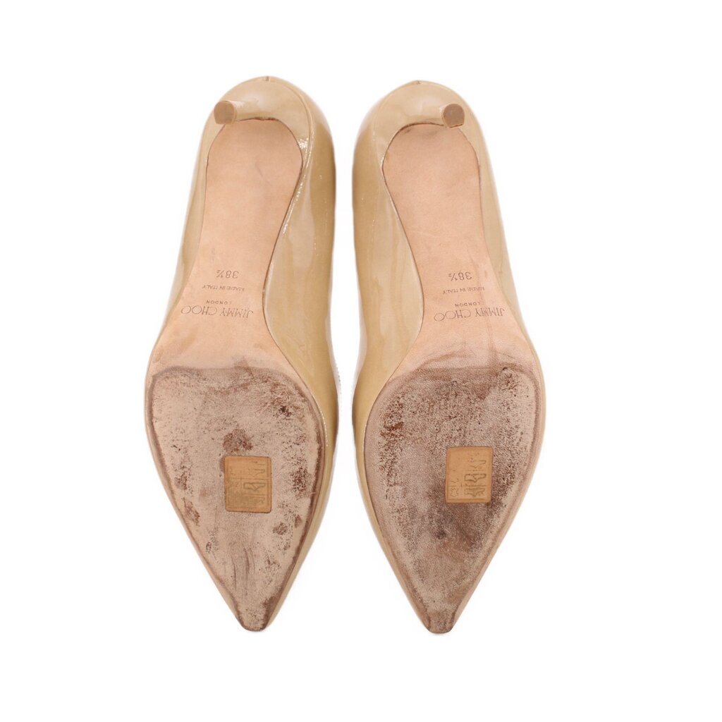 Nude patent leather pump bottoms showing soles and stamped insole text