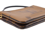 Close-up of brown monogram crossbody pochette top with gold zipper pull