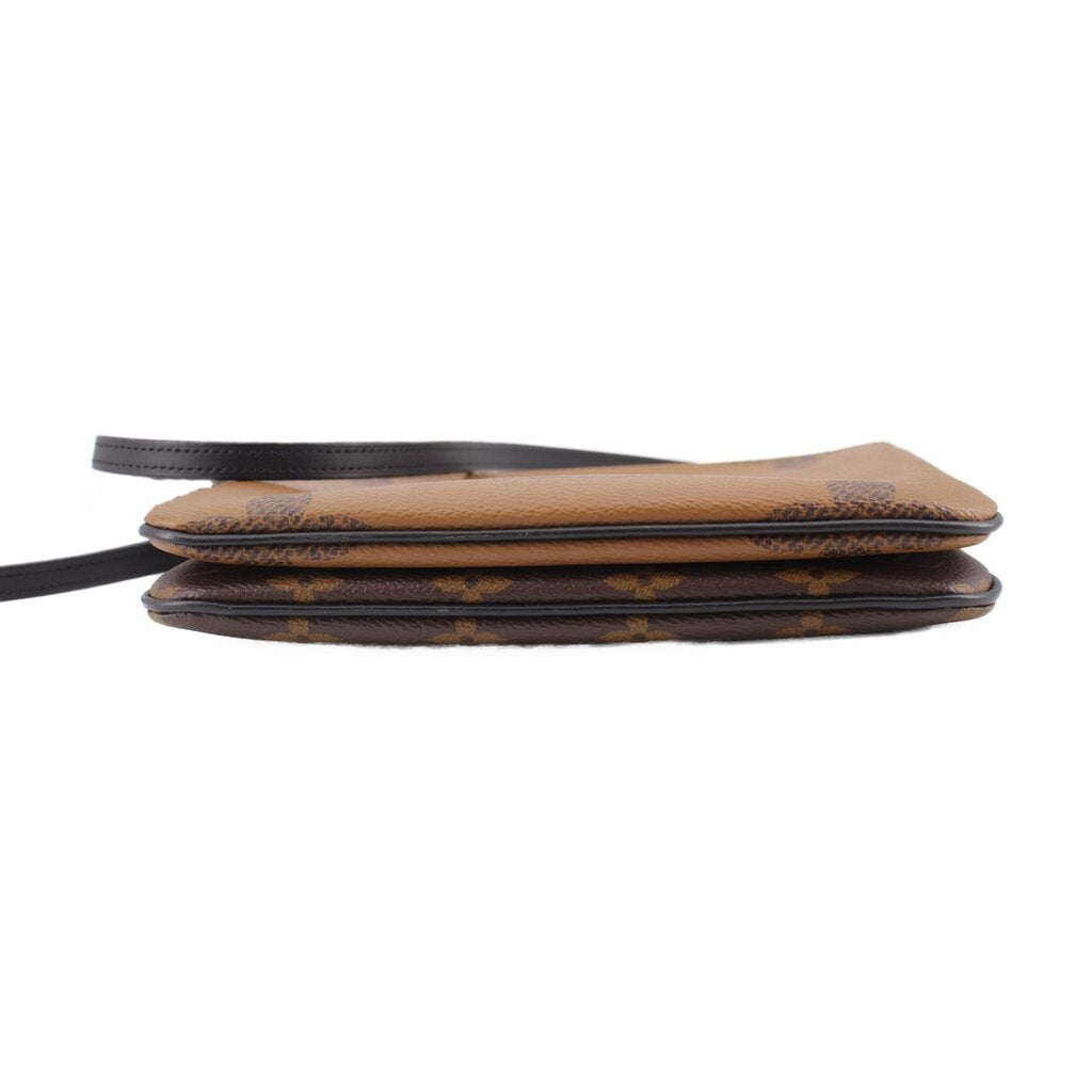 Monogram crossbody pochette side view with black trim and layered edge