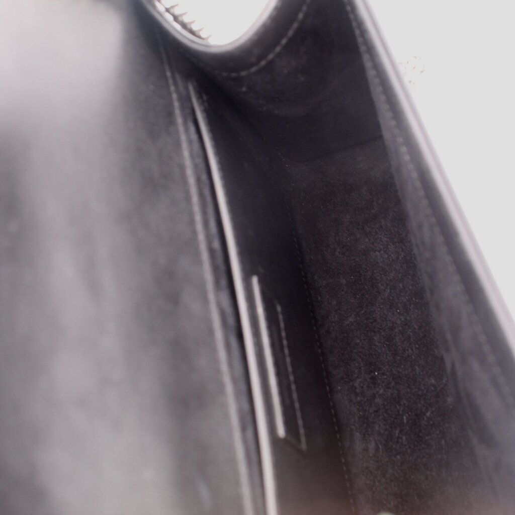 Black interior pocket view of SAINT LAURENT crossbody bag lining detail