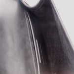 Black interior pocket view of SAINT LAURENT crossbody bag lining detail