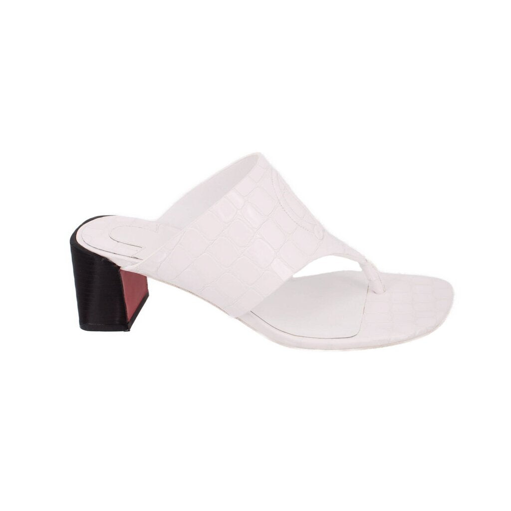 White mule slide sandal with embossed logo straps and black block heel