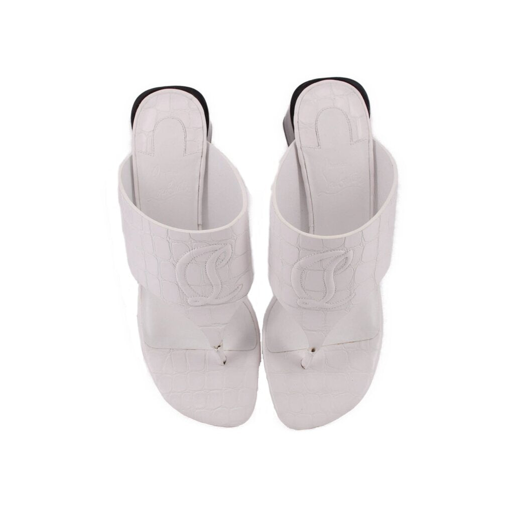 White slide sandals with embossed logo detail and open-toe straps