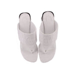 White slide sandals with embossed logo detail and open-toe straps