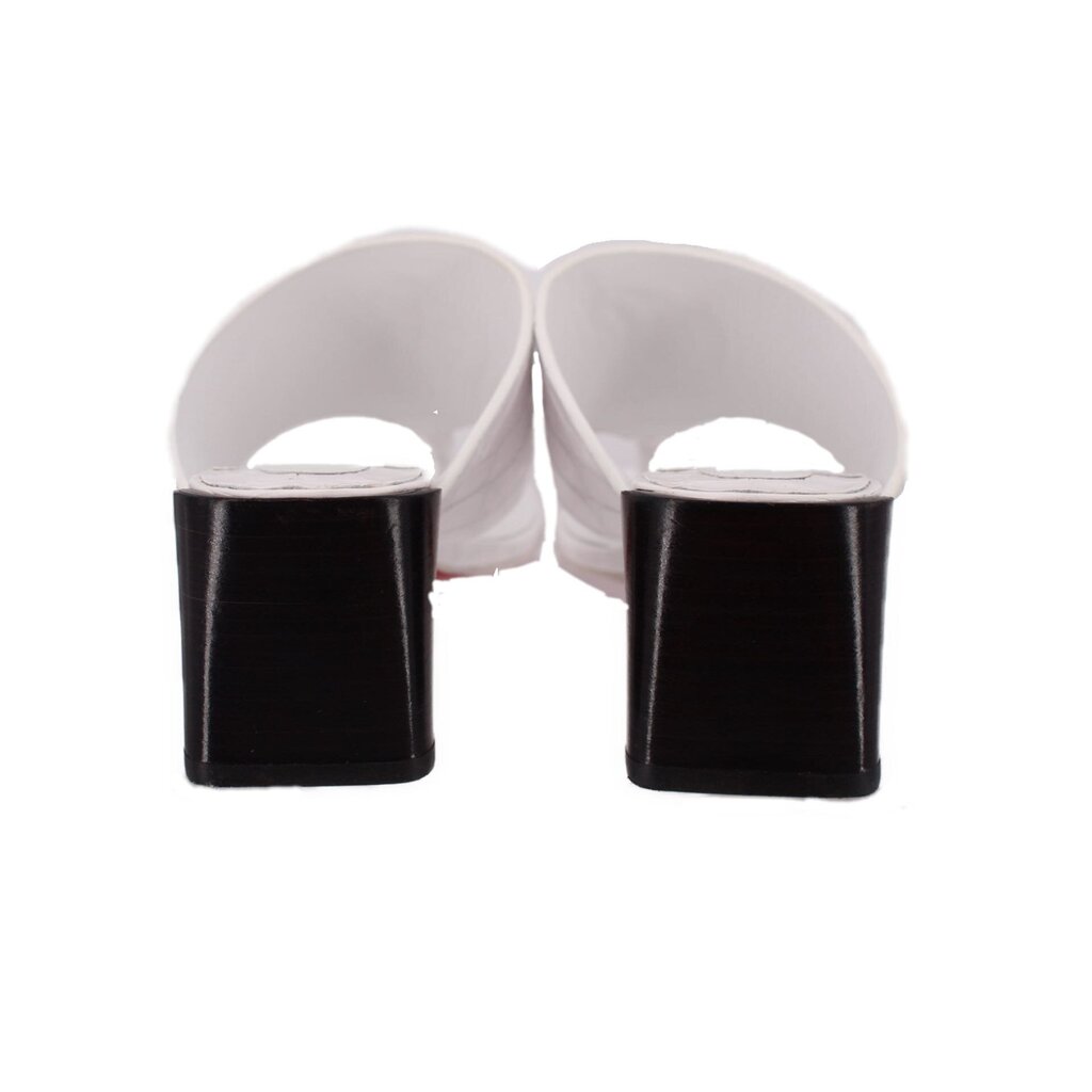 White slide sandals with black block heels and open heel back