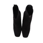 Black suede ankle booties with stacked block heels, back view
