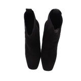 Black suede ankle booties with stacked block heels, back view