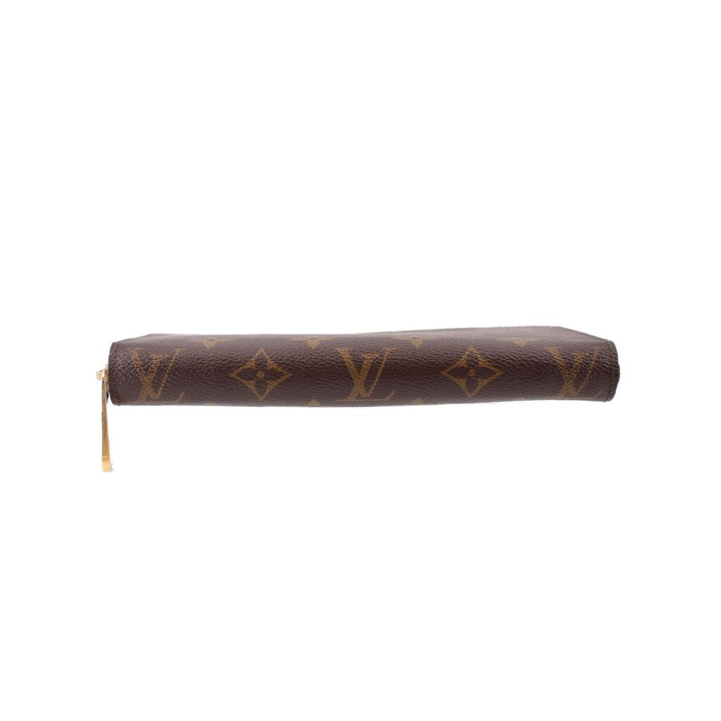 Zippy wallet with dark brown monogram canvas and gold-tone zipper along the side