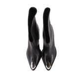 Black heeled booties with pointed toe and silver metallic accent