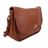 COACH crossbody bag in British tan leather with curved flap and adjustable shoulder strap