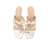 Metallic heeled sandals with open toe, cross straps, and slim stiletto heel
