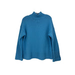 Blue turtleneck sweater with ribbed collar, cuffs, and wide sleeves
