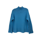Blue turtleneck sweater with ribbed collar, cuffs, and wide sleeves