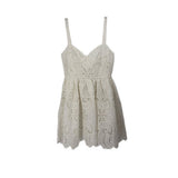 White lace baby-doll dress with spaghetti straps and scalloped hem