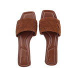 Brown suede slide sandals open-toe design with padded footbed and stitched upper
