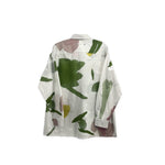 White back button-up shirt with green and yellow abstract print, long sleeves